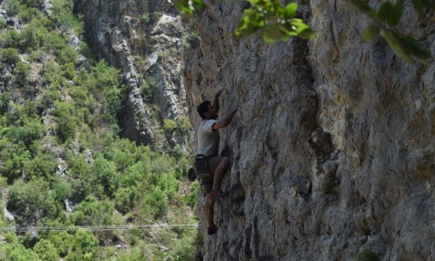 eco adventure club member ahtisham hameed climbs a rock face during a training session at shahdara on the outskirts of islamabad photo afp