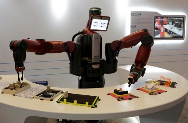 a baxter robot of rethink robotics picks up a business card as it performs during a display at the world economic forum photo reuters