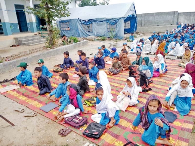 students sit on a mat during a class without any facilities at a government school in rabbat lower dir photo express