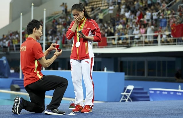 he zi receives a marriage proposal from diver qin kai after the medal ceremony photo reuters