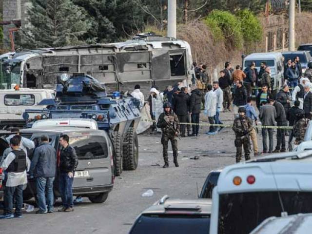 turkish special force police officers walk at the site of a bomb attack in diyarbakir southeastern turkey photo afp