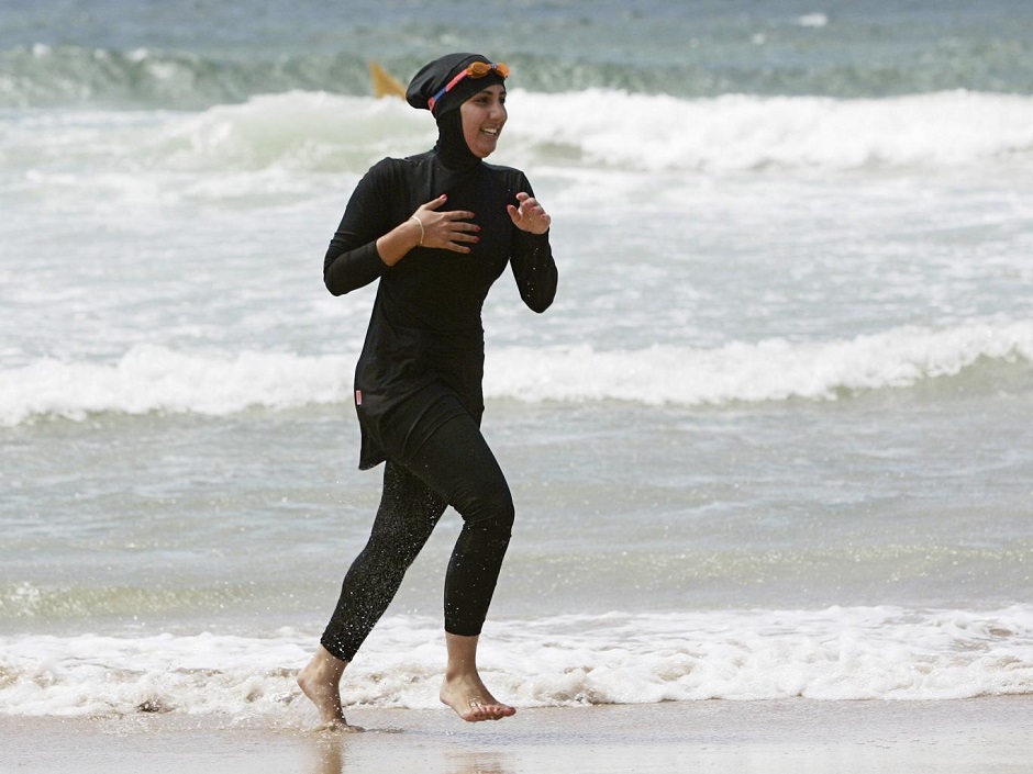 volunteer surf life saver mecca laalaa runs along a beach in sydney photo reuters