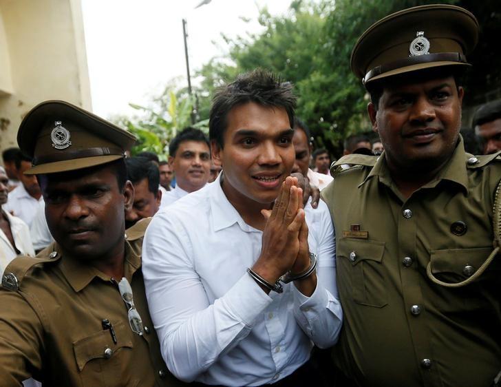 namal rajapaksa c son of former sri lanka 039 s president mahinda rajapaksa leaves with prison officers at court after being arrested in colombo sri lanka july 11 2016 photo reuters