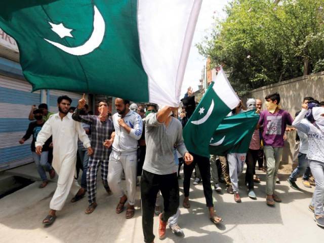 pakistani flags hoisted and carried during a rally in srinagar kashmir photo reuters