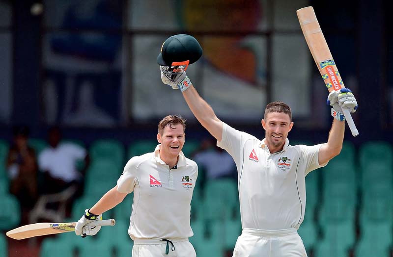 shaun marsh celebrates with captain steven smith after reaching his century mark which along with smith s 119 gave australia a slender lead on the third day photo afp