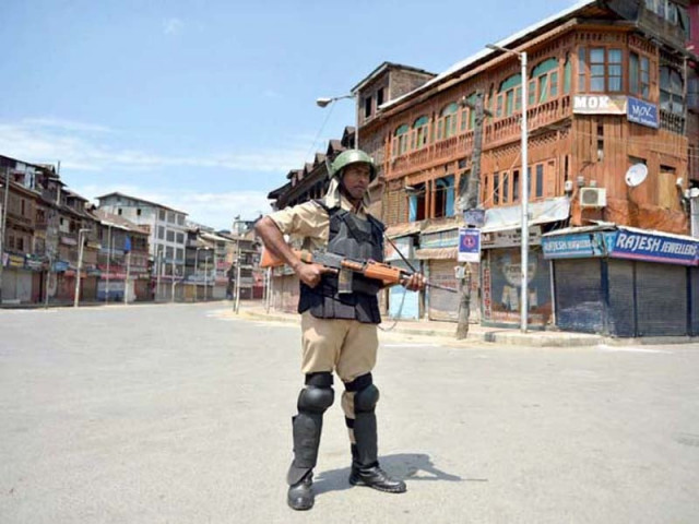 an indian paramilitary soldier stands guard in a market during a curfew in srinagar photo afp an indian paramilitary soldier stands guard in a market during a curfew in srinagar photo afp