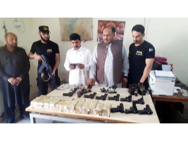 customs officials display the confiscated weapons to media at torkham border photo express