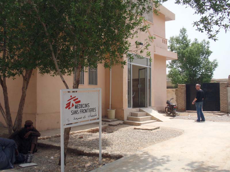 people sit near a sign board of medicines sans border at the dera murad jamali district headquarters hospital photo express