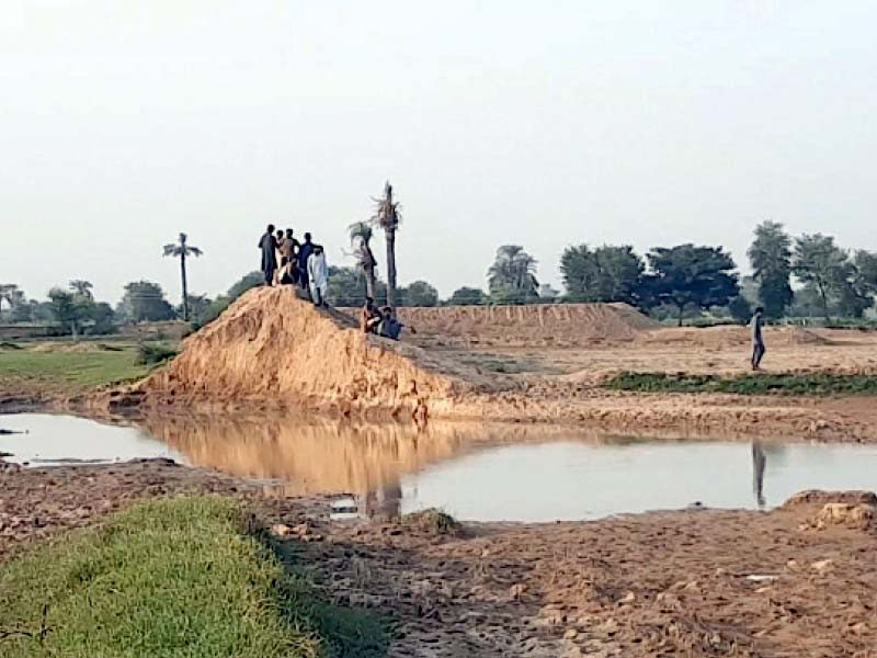 local people gather near the pond where five children drowned photo express