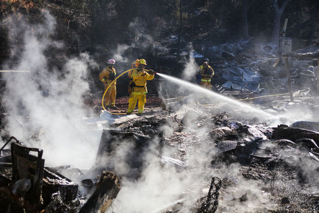 firefighters work to contain embers on the remains of a house destroyed by the clayton fire in lower lake california august 15th 2016 photo afp