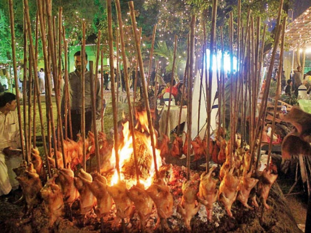 a vendor prepares the traditional sajji at the lok mela in islamabad photo online a vendor prepares the traditional sajji at the lok mela in islamabad photo online