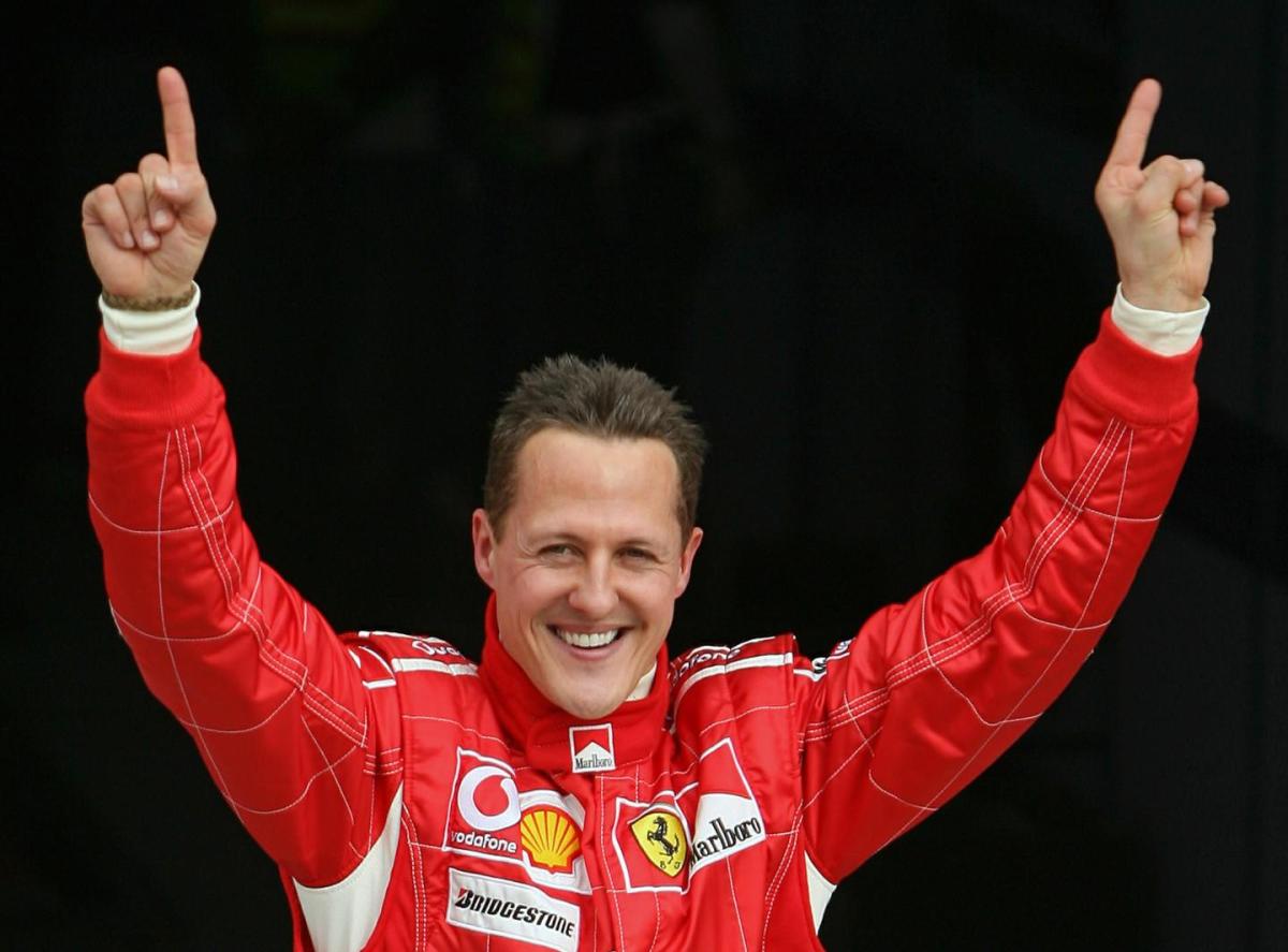 michael schumacher celebrates after taking the pole position at the end of the qualifying session for the bahrain formula one grand prix in 2006 photo afp