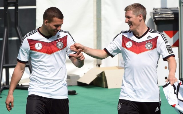 germany forward lukas podolski l chats with teammate and midfielder bastian schweinsteiger during the team 039 s training session photo afp