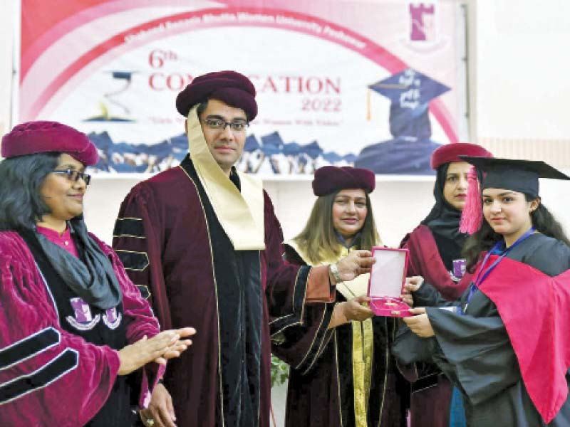 k p minister for higher education kamran bangash awards a medal to a student during the sbbwu s 6th convocation on wednesday photo ppi