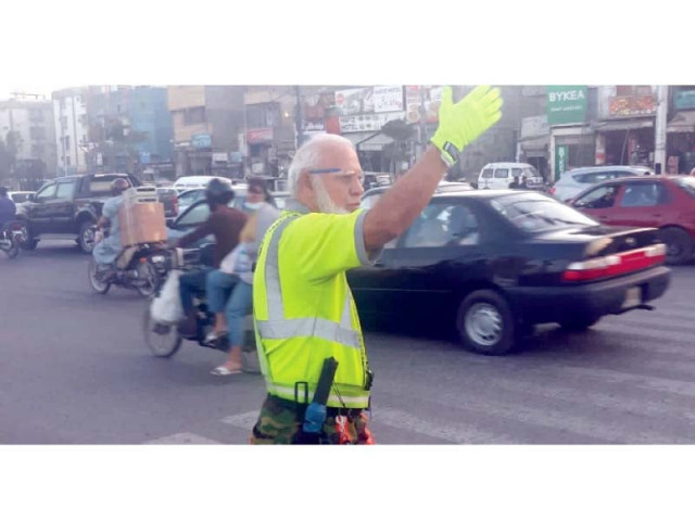 raja arshad ali controls traffic at a busy intersection on korangi road near national medical centre photo express raja arshad ali controls traffic at a busy intersection on korangi road near national medical centre photo express