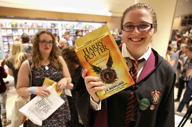 a woman holds copies of the book of the play of harry potter and the cursed child parts one and two at a bookstore in london britain july 31 2016 photo reuters