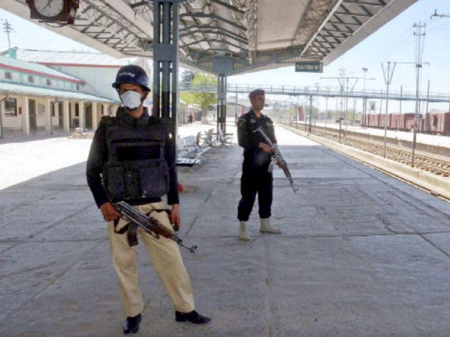 two policemen stand at the ready at railway station in quetta on thursday photo ppi two policemen stand at the ready at railway station in quetta on thursday photo ppi