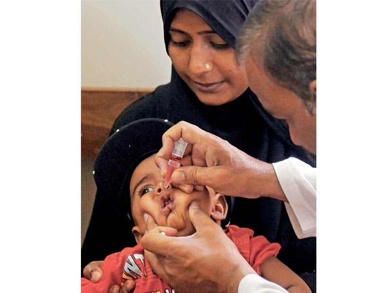 a health worker administers polio vaccine drops to a child during a polio campaign in karachi on may 2 2016 photo file