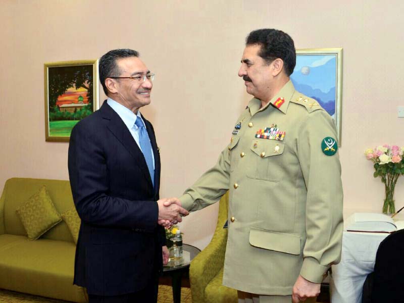gen raheel shakes hands with the malaysian defence minister photo ispr