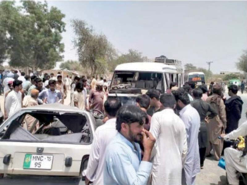 rescue workers and passersby look over the mangled remains of a car that collided with a coaster near vehari eight people all part of the same family were killed photo express