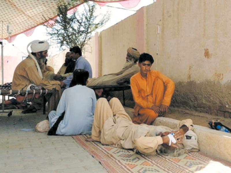 a cholera patient lies on ground at a hospital due to lack of beds in pir koh dera bugti photo express