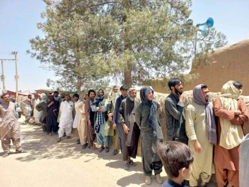 voters line up outside a polling station in the mastung district of balochistan during lg polls held on may 29 photo express