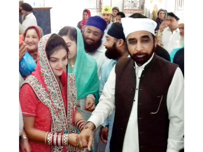 a woman ties a rakhi on siddiqul farooq s wrist photo express