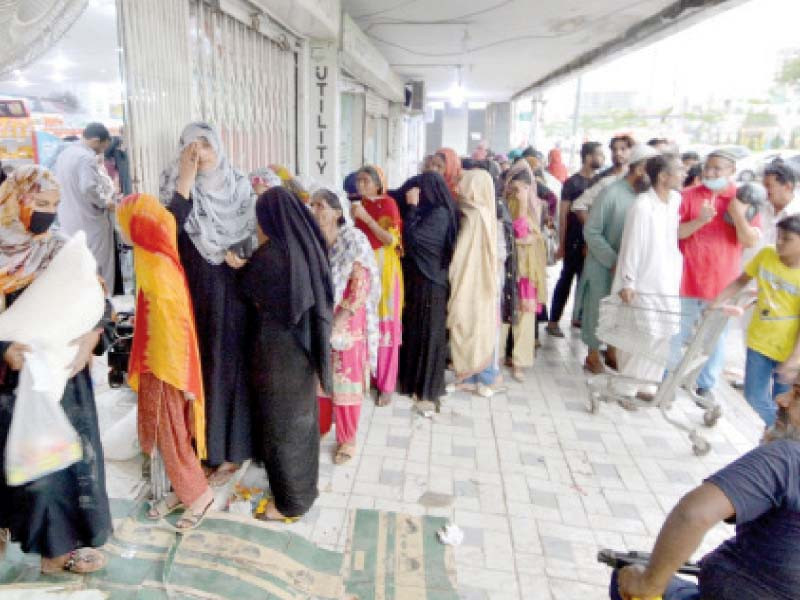 women stand in a line to enter an outlet of the utility stores corporation to buy subsidised flour photo jalal qureshi express