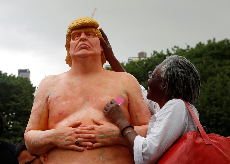 a woman touches a naked statue of presidential nominee donald trump that was left in union square park in new york city us photo reuters