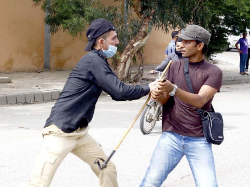 a protesting teacher grabs baton of a cop during a protest outside the cm house on monday photo ppi