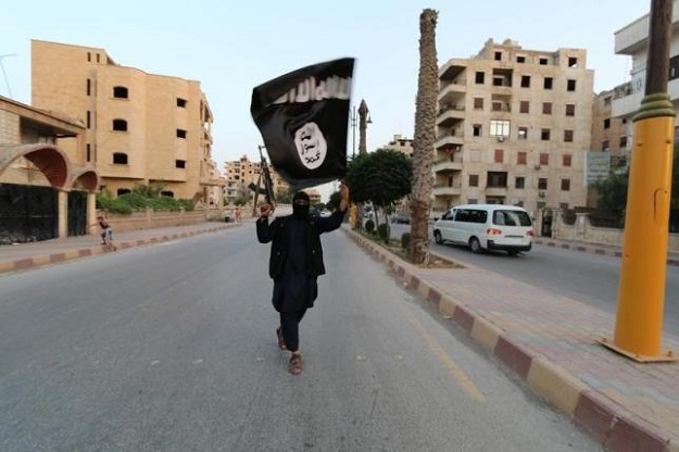 a member loyal to the islamic state waves an is flag photo reuters