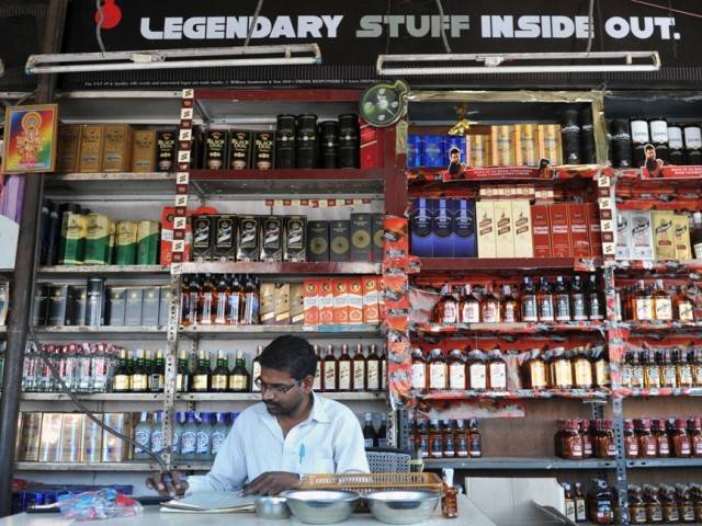 an indian employee writes down stock at an alcohol store in hyderabad photo afp