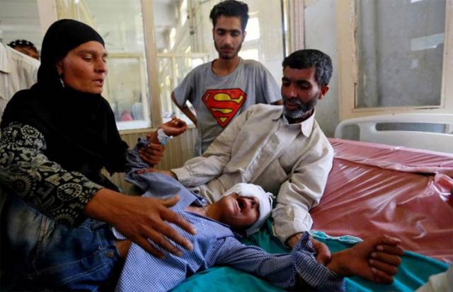 parents comfort their son whom they say was injured by pellets shot by security forces in srinagar following weeks of violence in kashmir photo reuters