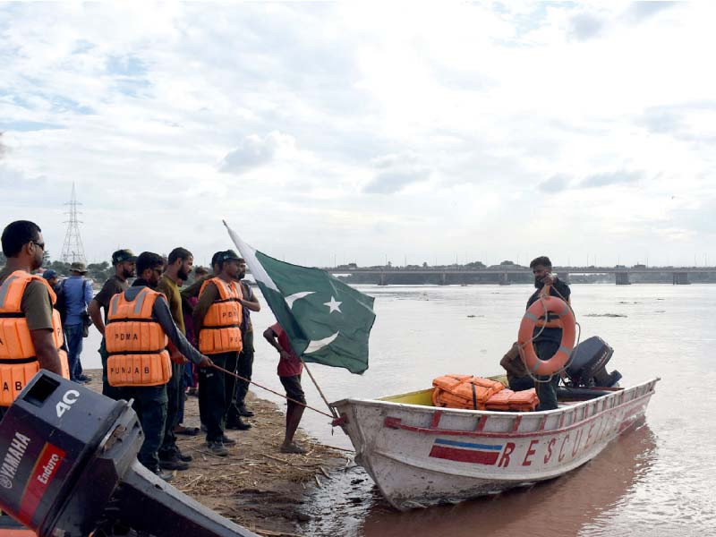 pdma staff patrols the ravi river in a boat near lahore a rescue operation was initiated after india released water into the river triggering fears of flooding photo online