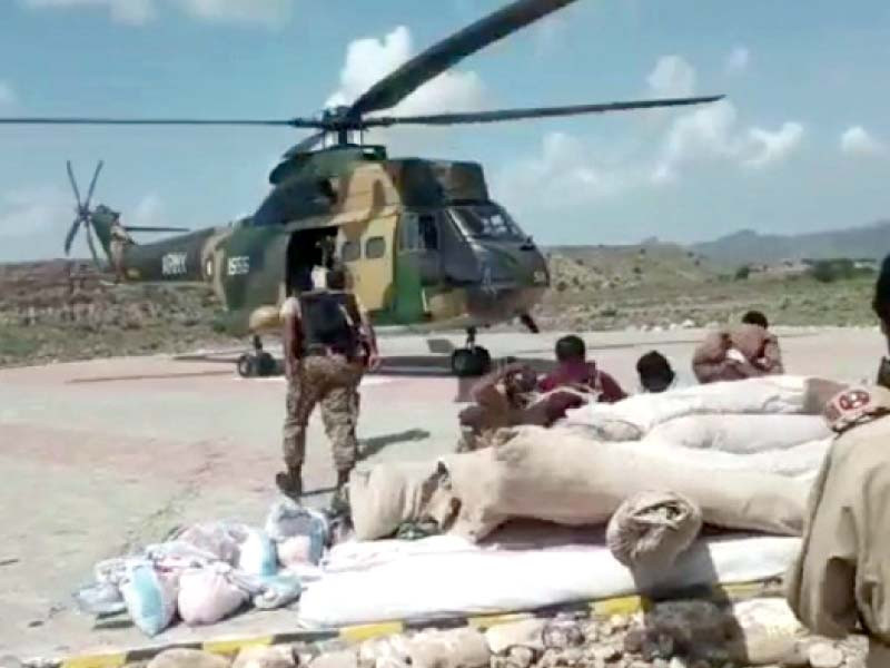 a pakistan army helicopter delivers aid packages to flood victims in dera ghazi khan photo express