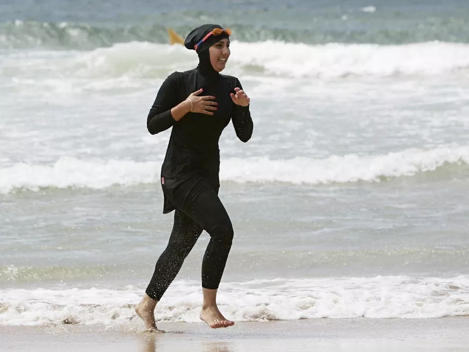 volunteer surf life saver mecca laalaa runs along a beach photo reuters volunteer surf life saver mecca laalaa runs along a beach photo reuters