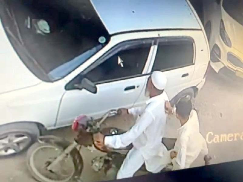 cctv footage shows an elderly man drive a bike while his accomplice snatches cash and valuables from the passengers in a car photo express