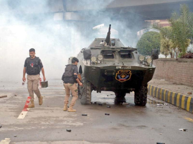 police lob tear gas shells and use batons to disperse protesting schoolteachers in peshawar photo ppi police lob tear gas shells and use batons to disperse protesting schoolteachers in peshawar photo ppi