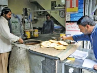 workers prepare toasted sesame flatbreads for customers in a traditional oven at the shahadat naan centre in kartarpura food street rawalpindi photo agha mahroz express