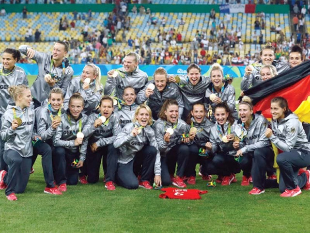 germany s players pose with their first ever gold medals after their team s victory over sweden during the rio 2016 olympic games photo afp germany s players pose with their first ever gold medals after their team s victory over sweden during the rio 2016 olympic games photo afp