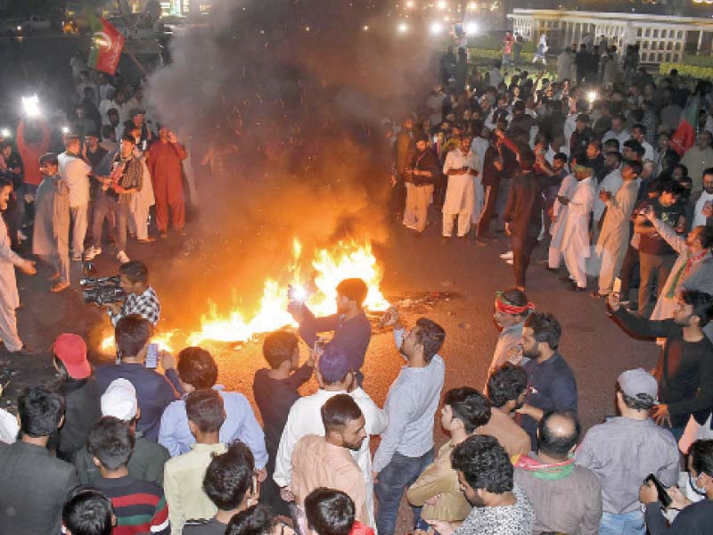 pti workers and supporters chant slogans and burn tyres at liberty chowk protesting the gun attack on the pti convoy in wazirabad photo online