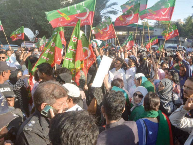 police try to stop pti activists on sharae faisal from heading towards the red zone during a protest against the botched assassination attempt on imran khan photo express