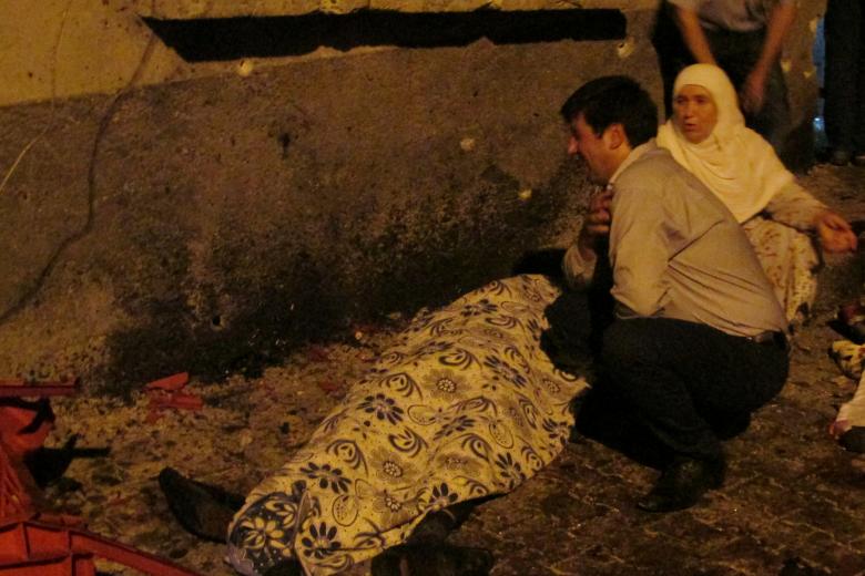 a man and a woman mourn next to a body of one the victims of a blast targeting a wedding ceremony in the southern turkish city of gaziantep turkey august 20 2016 ihlas news photo reuters