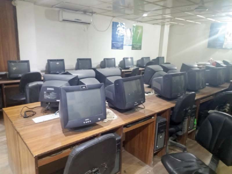 outdated computers lie on table of karachi university central library most of these machines are out of order photo express