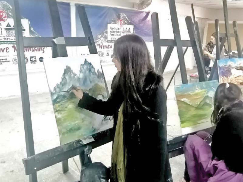 artists demonstrating painting skills at a live painting competition titled women move mountains at the fatima jinnah women university in rawalpindi photo express