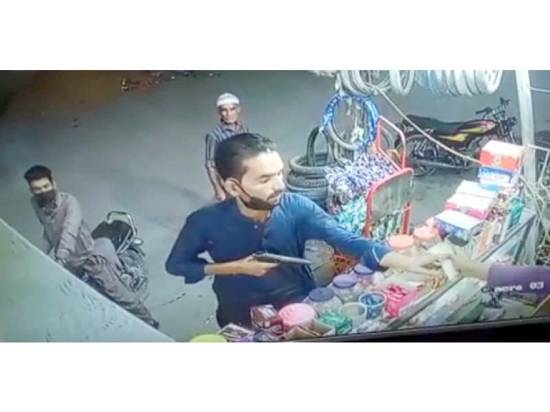 this screengrab from an undated cctv camera footage shows a suspect robbing a store in a karachi neighbourhood in karachi photo express