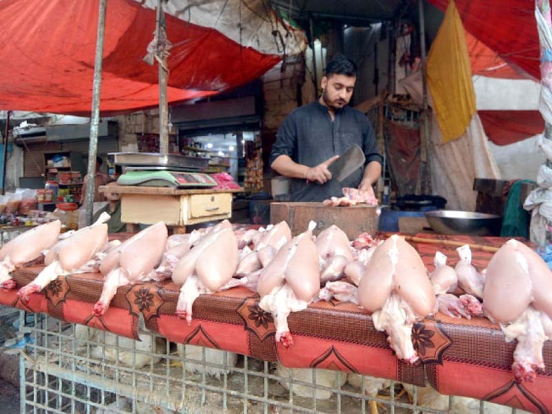 a vendor sells poultry meat at a shop in a karachi s neighbourhood on wednesday photo jalal qureshi express