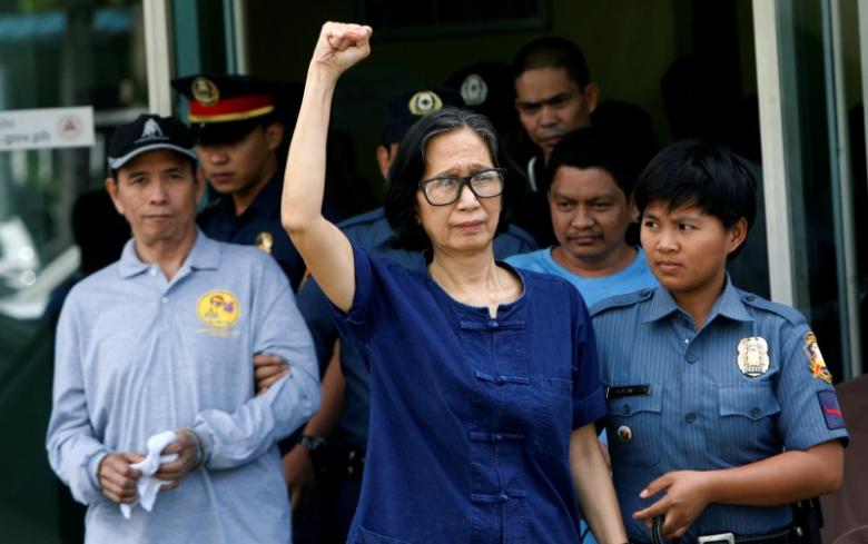 philippines communist leaders benito tiamzon l and wife wilma austria tiamzon c are escorted by police after they were arrested in manila march 23 2014 photo reuters