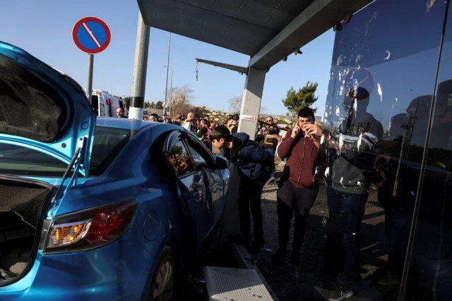 israelis look at the car on the scene where a suspected ramming attack took place in jerusalem february 10 2023 photo reuters israelis look at the car on the scene where a suspected ramming attack took place in jerusalem february 10 2023 photo reuters