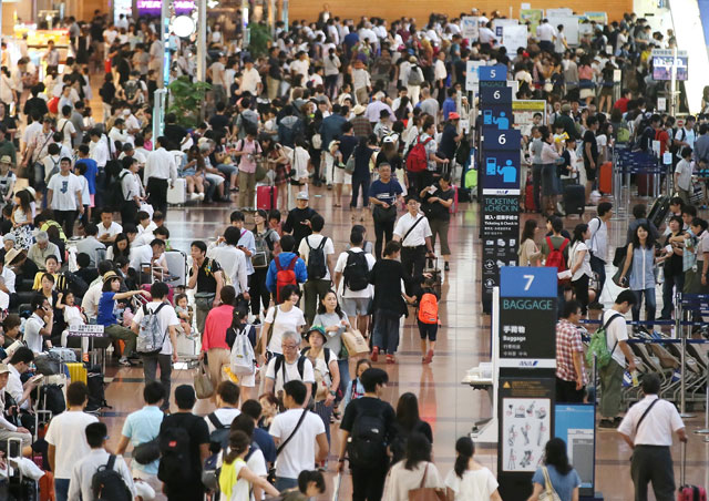 people crowd at the departure lobby at haneda airport in tokyo on august 22 2016 photo afp